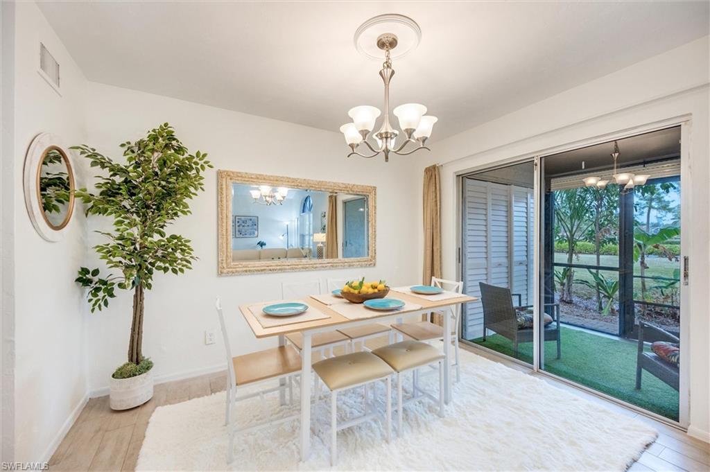 940 Augusta Boulevard, Unit D939 Naples, FL 34113 - Photo 7 of 42 a dining room with furniture a chandelier and window