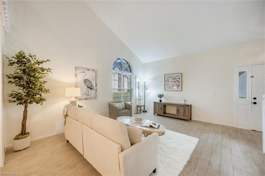 940 Augusta Boulevard, Unit D939 Naples, FL 34113 - Photo 10 of 42 a living room with furniture and a potted plant