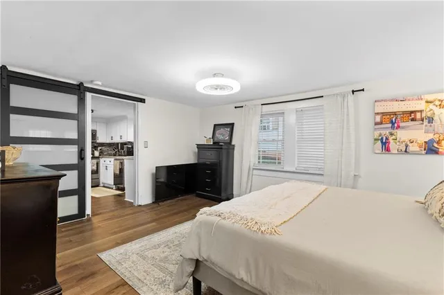a bedroom with a bed and wooden floor