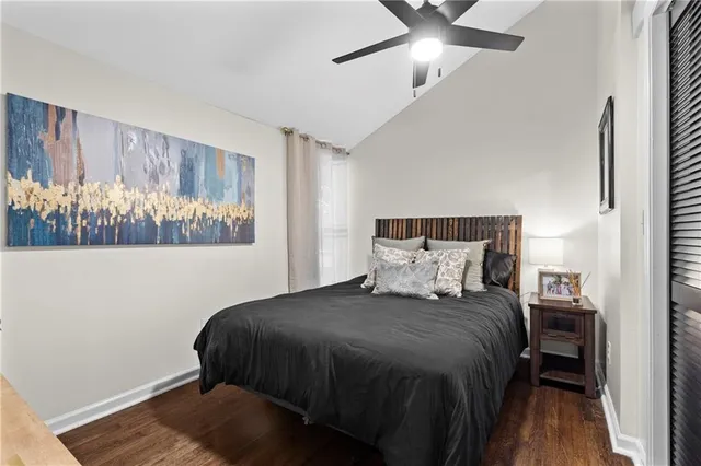 a bed sitting in a bedroom next to a window and a chandelier