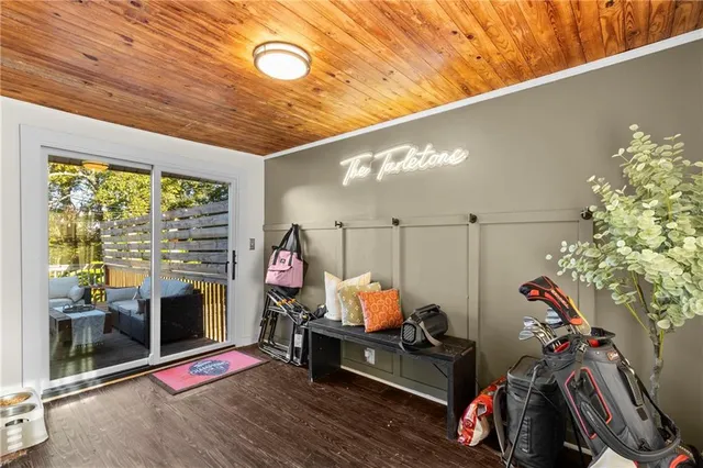 a view of a hallway with wooden floor and door
