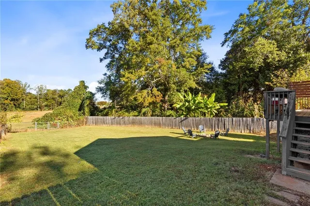 a swimming pool with an outdoor space and seating area