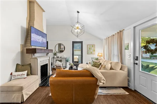 a living room with fireplace furniture and a chandelier