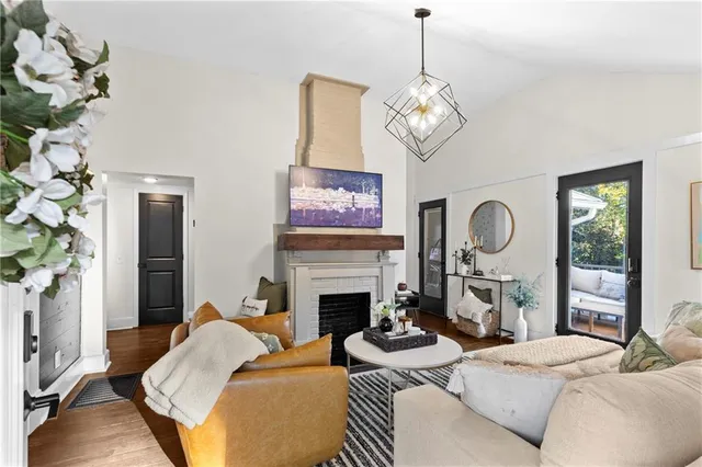 a living room with furniture chandelier and a fireplace