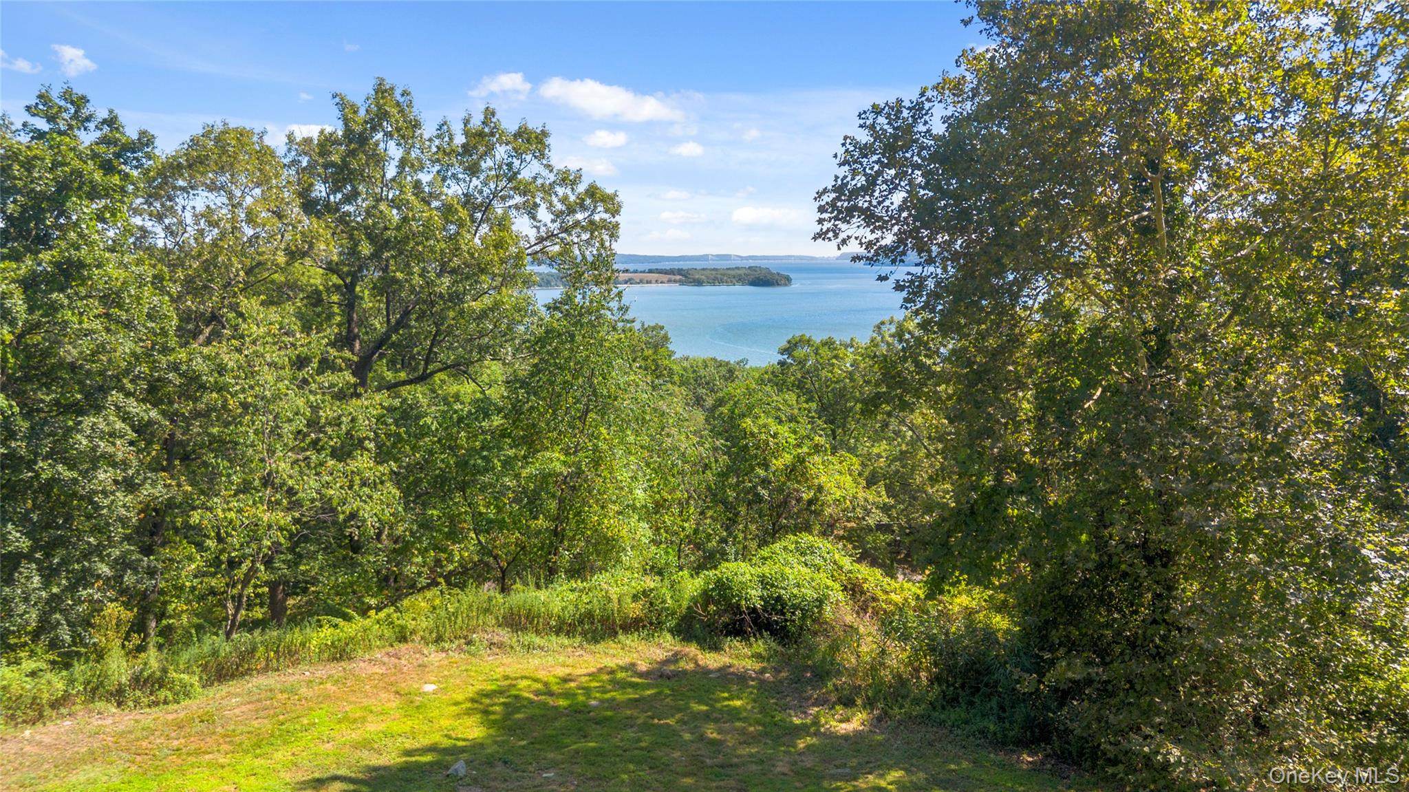 3 Prickly Pear Hill Road Croton-on-Hudson, NY 10520 - Photo 12 of 16 a view of a lake with a building in the background