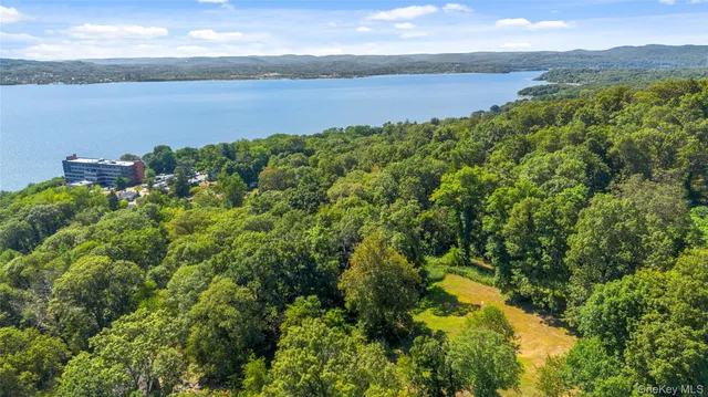 a view of lake with green landscape