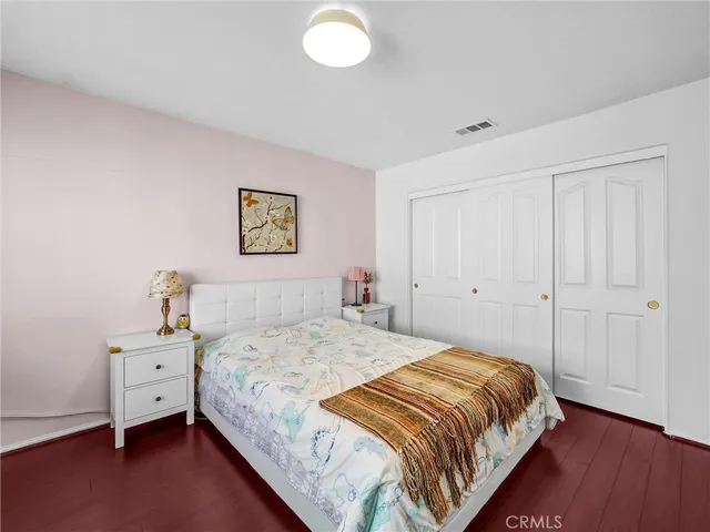 a bedroom with a bed and a closet