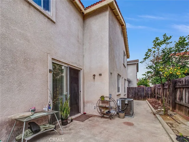 a backyard of a house with table and chairs
