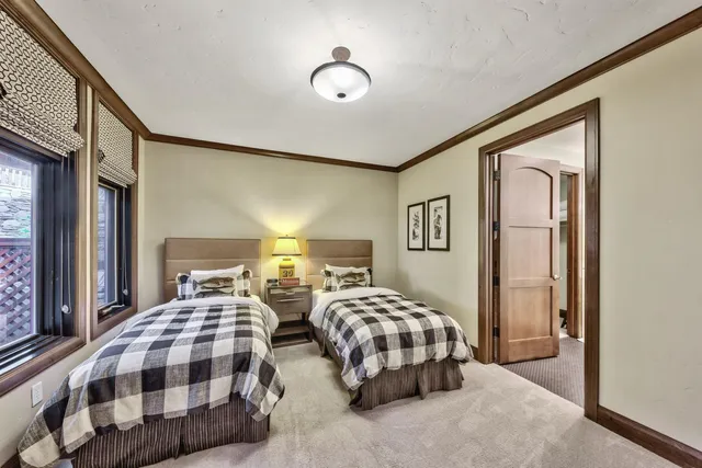a bedroom with two beds and a chandelier