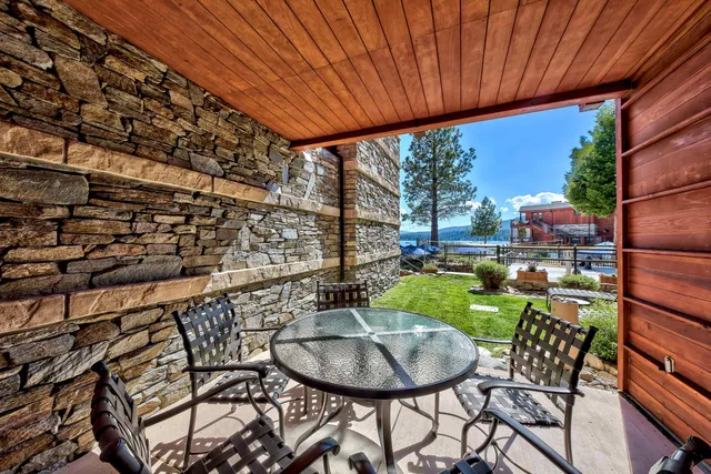 a balcony with a table and chairs
