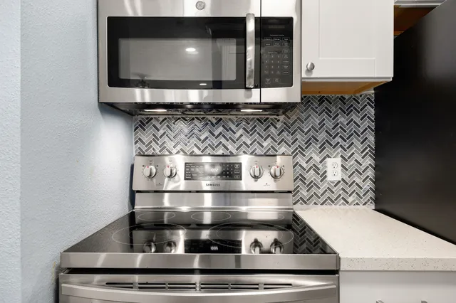 a stove top oven sitting inside of a kitchen