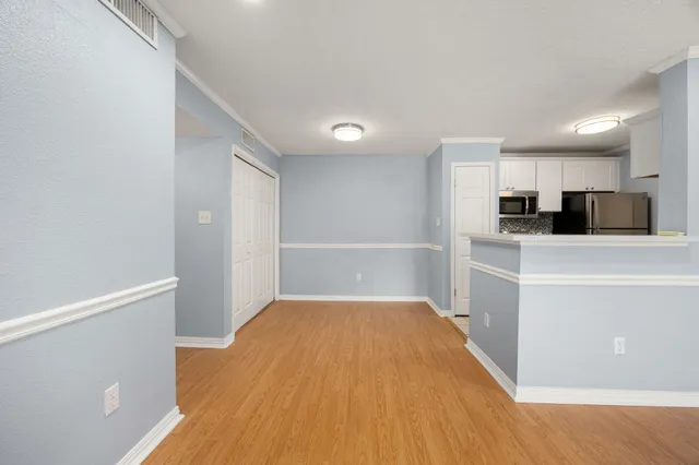 a view of a kitchen with microwave and cabinets