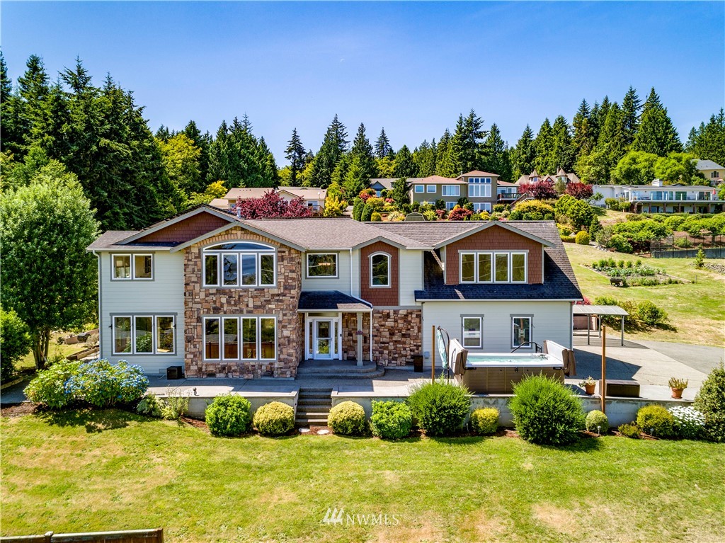 20821 Miller Bay Road Northeast Poulsbo, WA 98370 - Photo 2 of 40 a aerial view of a house with swimming pool and green yard