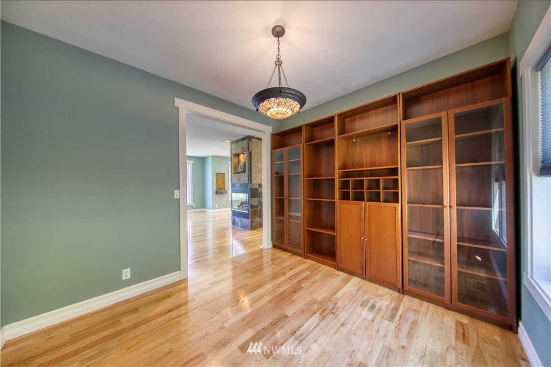 20821 Miller Bay Road Northeast Poulsbo, WA 98370 - Photo 13 of 40 a view of a room with wooden floor and white walls