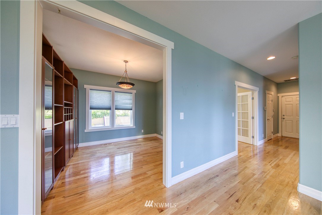 20821 Miller Bay Road Northeast Poulsbo, WA 98370 - Photo 15 of 40 a view of a hallway with wooden floor and windows