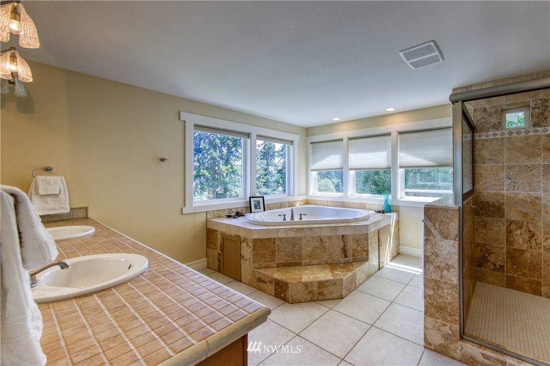 20821 Miller Bay Road Northeast Poulsbo, WA 98370 - Photo 20 of 40 a living room with a table and chairs