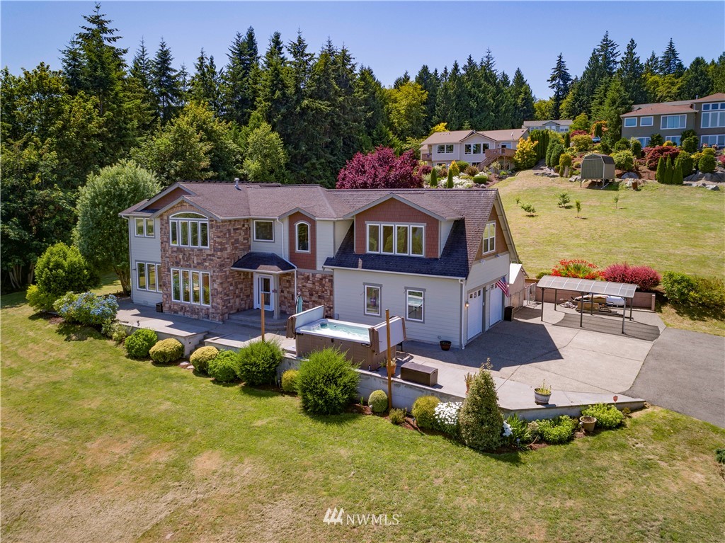 20821 Miller Bay Road Northeast Poulsbo, WA 98370 - Photo 3 of 40 a aerial view of a house with swimming pool garden and patio