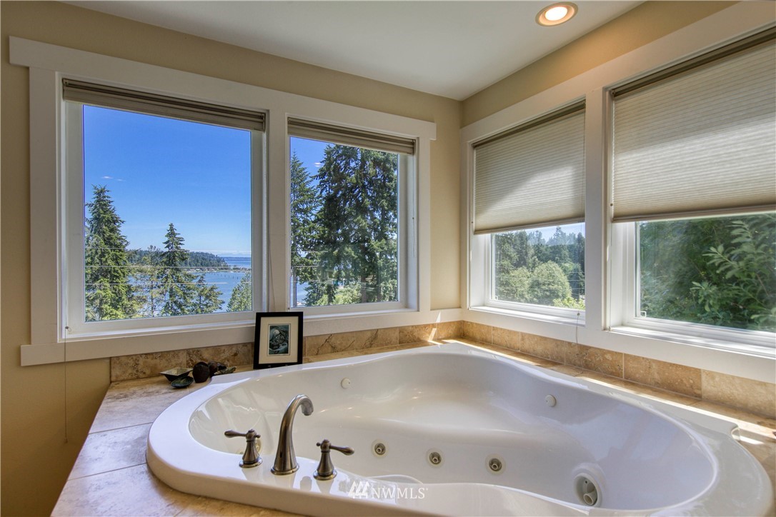 20821 Miller Bay Road Northeast Poulsbo, WA 98370 - Photo 21 of 40 a white bath tub sitting in a bathroom next to a window