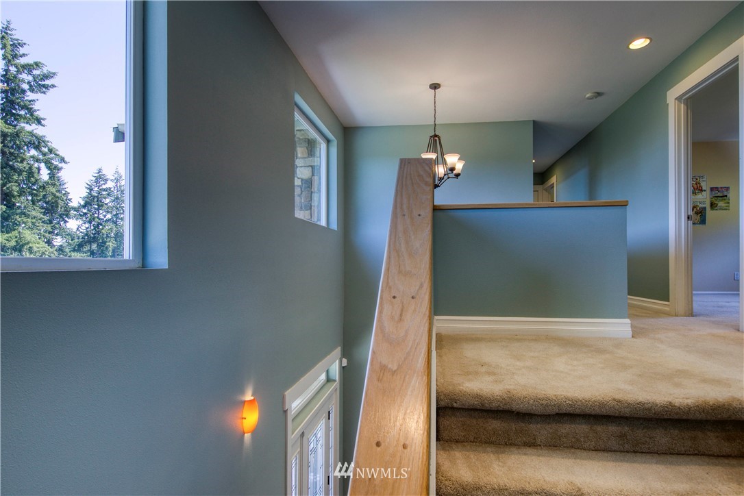 20821 Miller Bay Road Northeast Poulsbo, WA 98370 - Photo 39 of 40 a view of a hallway with a chandelier