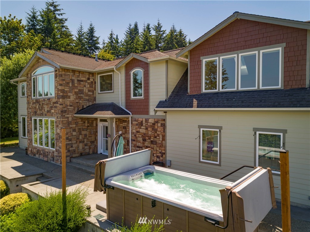 20821 Miller Bay Road Northeast Poulsbo, WA 98370 - Photo 5 of 40 a front view of a house with balcony