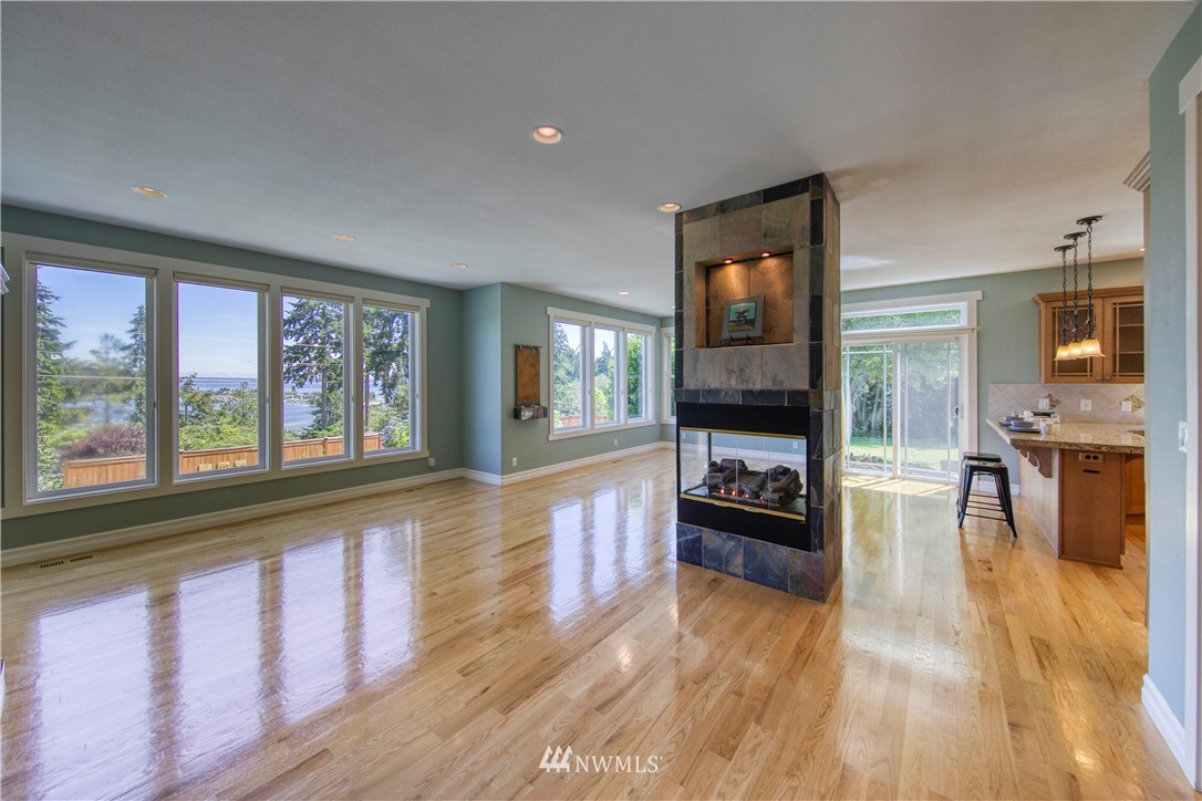 20821 Miller Bay Road Northeast Poulsbo, WA 98370 - Photo 6 of 40 a view of a living room kitchen with a stove and a large window