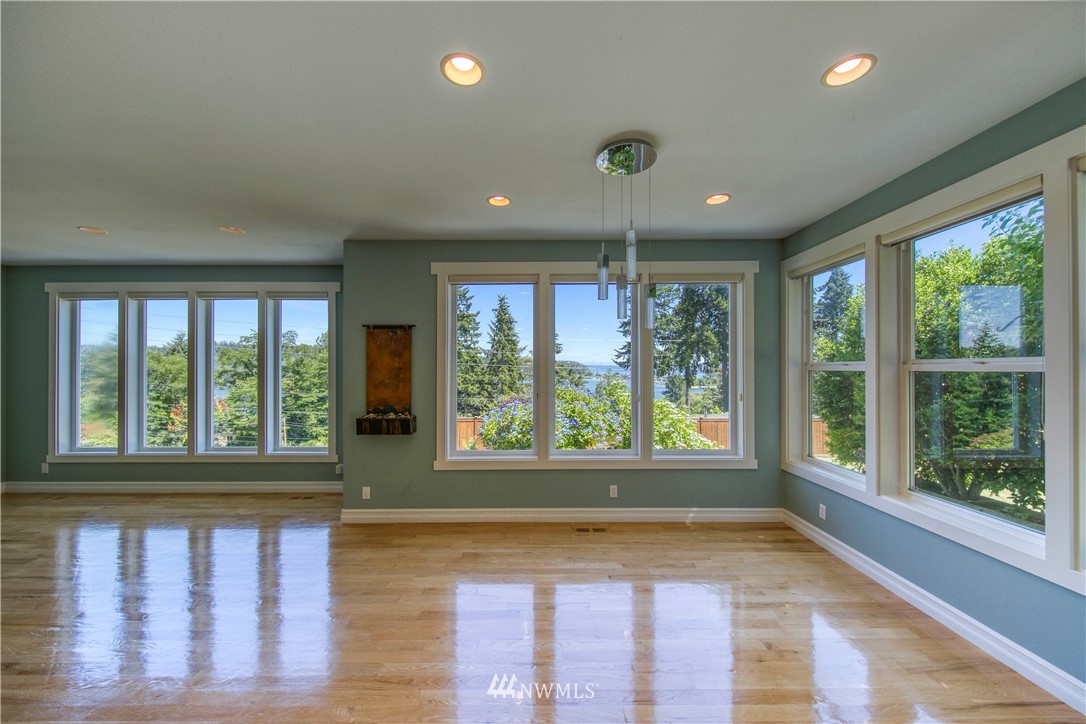 20821 Miller Bay Road Northeast Poulsbo, WA 98370 - Photo 8 of 40 a view of an empty room with wooden floor and a window