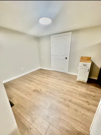 a view of a room with wooden floor