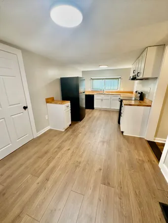 a view of kitchen with furniture and wooden floor