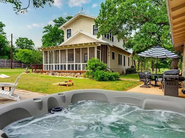 a view of a house with swimming pool and a yard