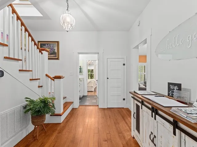 a view of a kitchen and an entryway with wooden floor