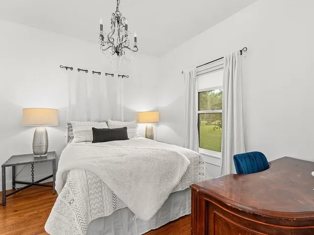 a bedroom with a bed and a lamp on table