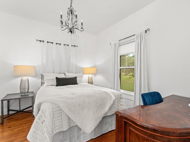44 Segner Road Fredericksburg, TX 78624 - Photo 15 of 21 a bedroom with a bed and a lamp on table