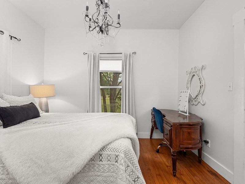 44 Segner Road Fredericksburg, TX 78624 - Photo 16 of 21 a bedroom with a bed and a chair