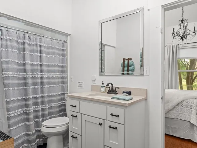 a bathroom with a sink toilet and shower