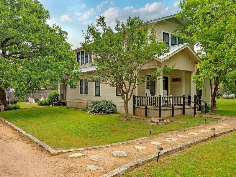44 Segner Road Fredericksburg, TX 78624 - Photo 2 of 21 a front view of a house with garden