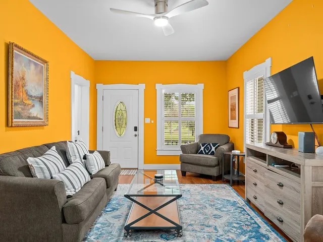 a living room with furniture and a flat screen tv