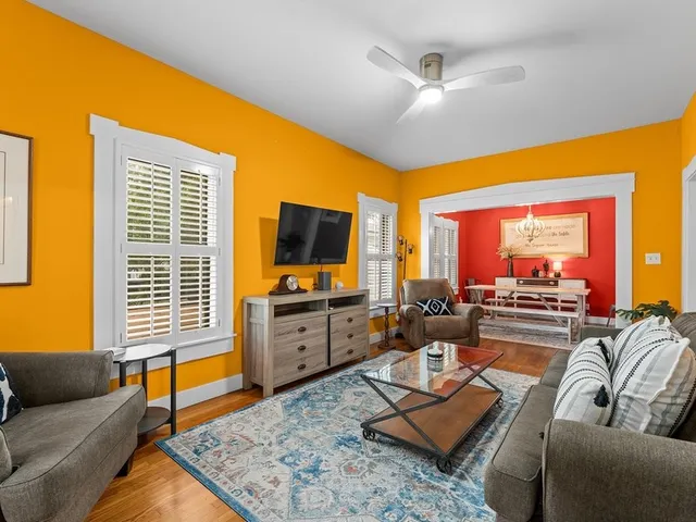 a living room with furniture and a flat screen tv