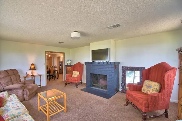 a bedroom with a bed and a dresser next to a window