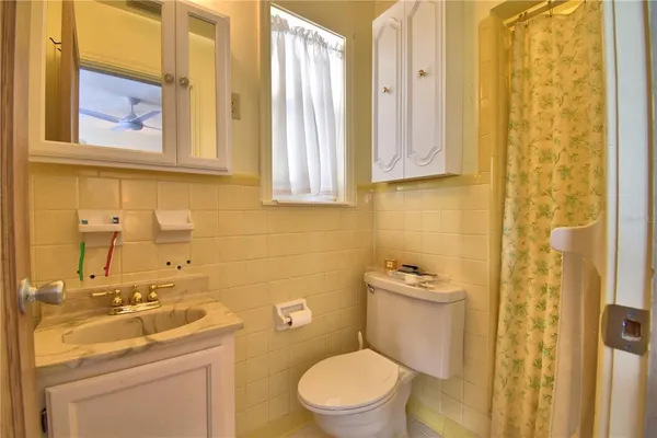 a front view of house with yard and trees around