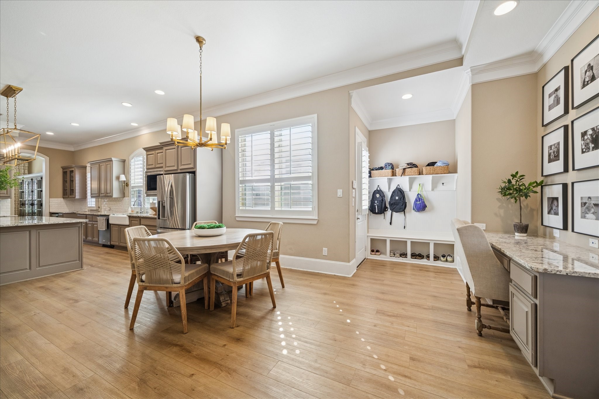 2914 Rutherford Pl Court Katy, TX 77494 - Photo 13 of 36 Sunlit breakfast area with designer chandelier and adjacent built-in workspace, creating a functional and inviting daily hub.