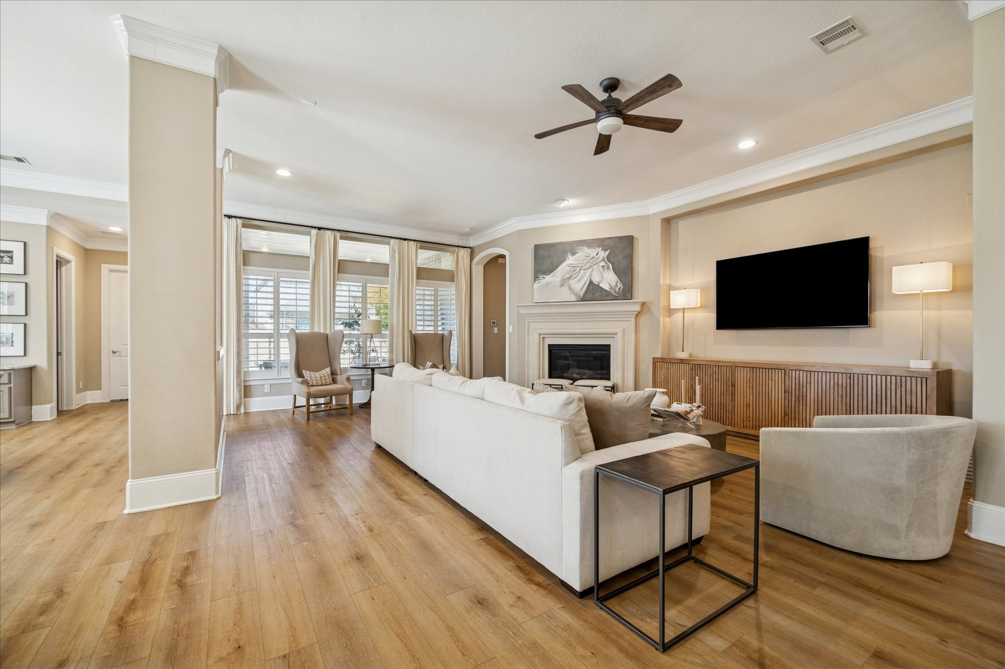 2914 Rutherford Pl Court Katy, TX 77494 - Photo 2 of 36 Light-filled living room featuring a gas fireplace, custom millwork, and an open layout ideal for everyday living.