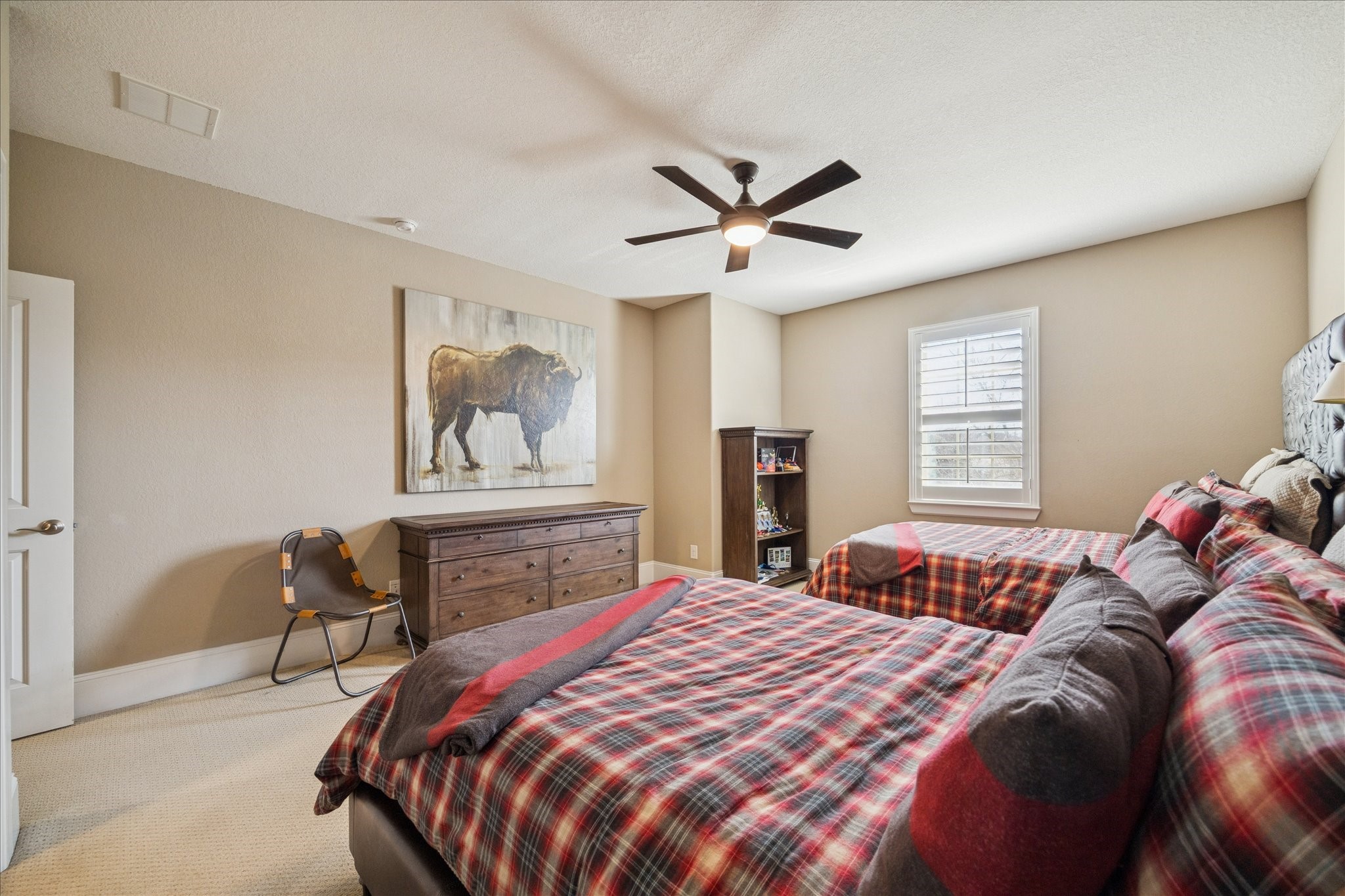 2914 Rutherford Pl Court Katy, TX 77494 - Photo 23 of 36 Generously sized secondary bedroom with plush carpet, ceiling fan, and neutral tones suitable for a variety of furniture layouts.