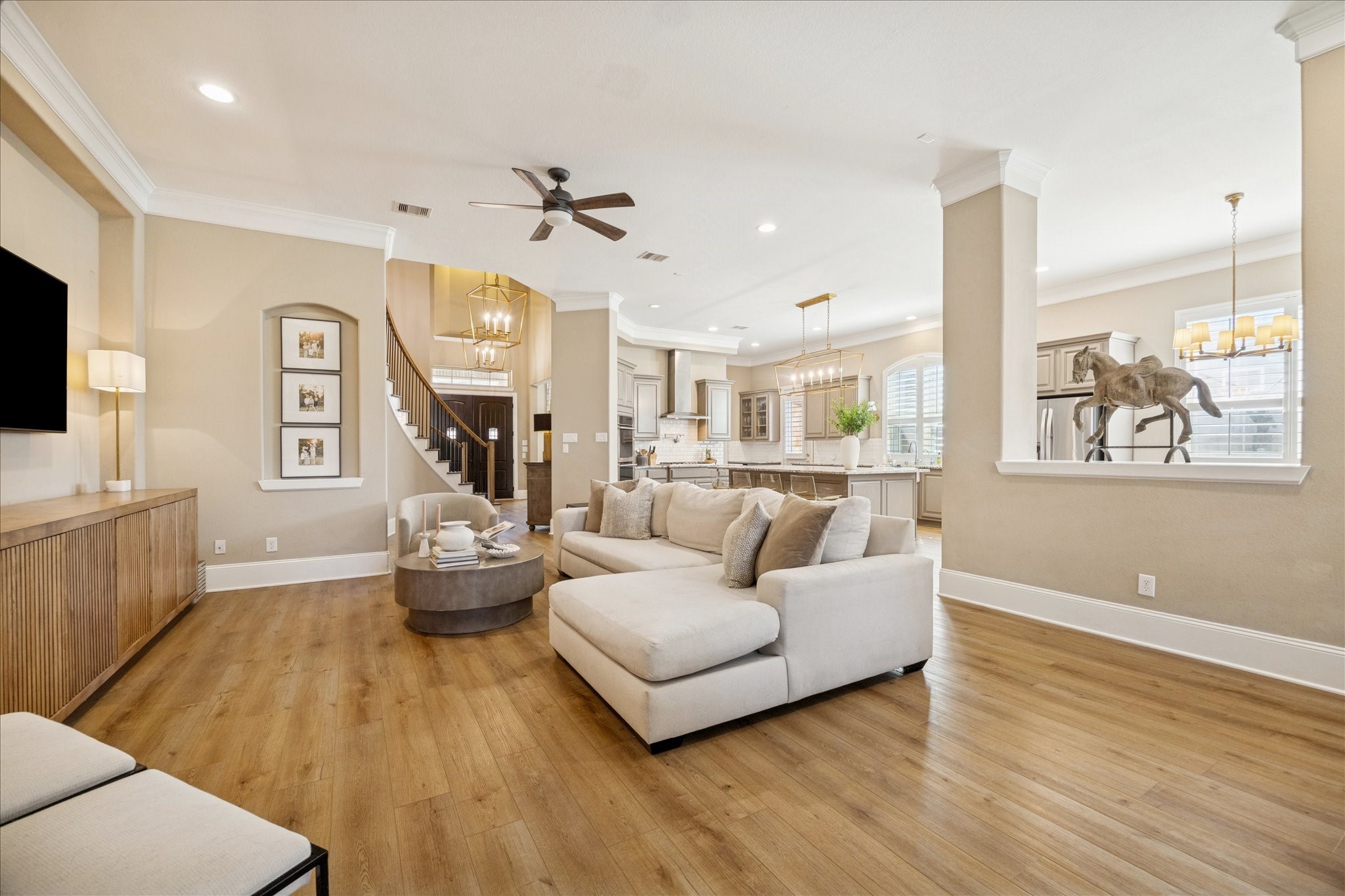 2914 Rutherford Pl Court Katy, TX 77494 - Photo 10 of 36 Spacious main living area with updated flooring, neutral tones, and architectural columns, offering an open layout that connects effortlessly to the kitchen and dining area.