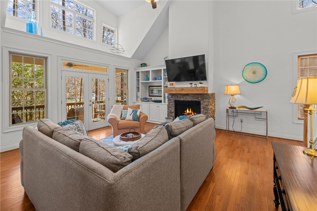 7 Divots Landing Salem, SC 29676 - Photo 12 of 47 This bright living area features abundant natural light, a cozy fireplace, and rich hardwood floors.