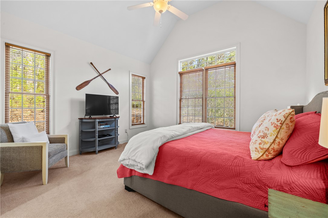 7 Divots Landing Salem, SC 29676 - Photo 19 of 47 This airy bedroom features high vaulted ceilings and ample natural light, creating a serene retreat.