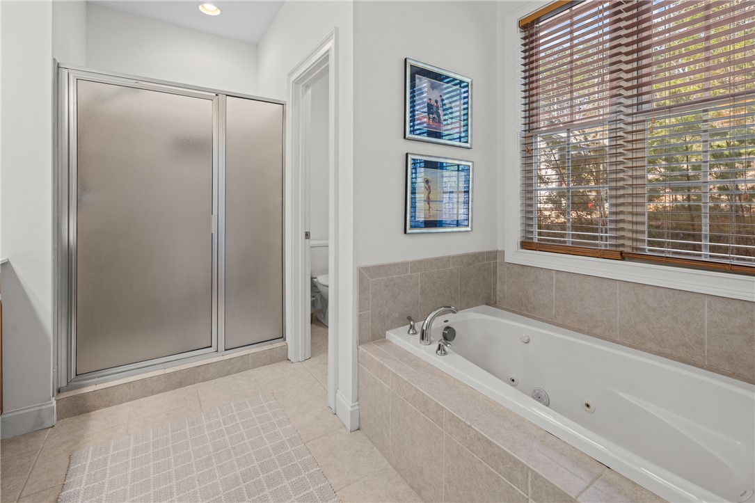 7 Divots Landing Salem, SC 29676 - Photo 23 of 47 This bathroom features a shower and a built-in tub, providing a practical and comfortable retreat.