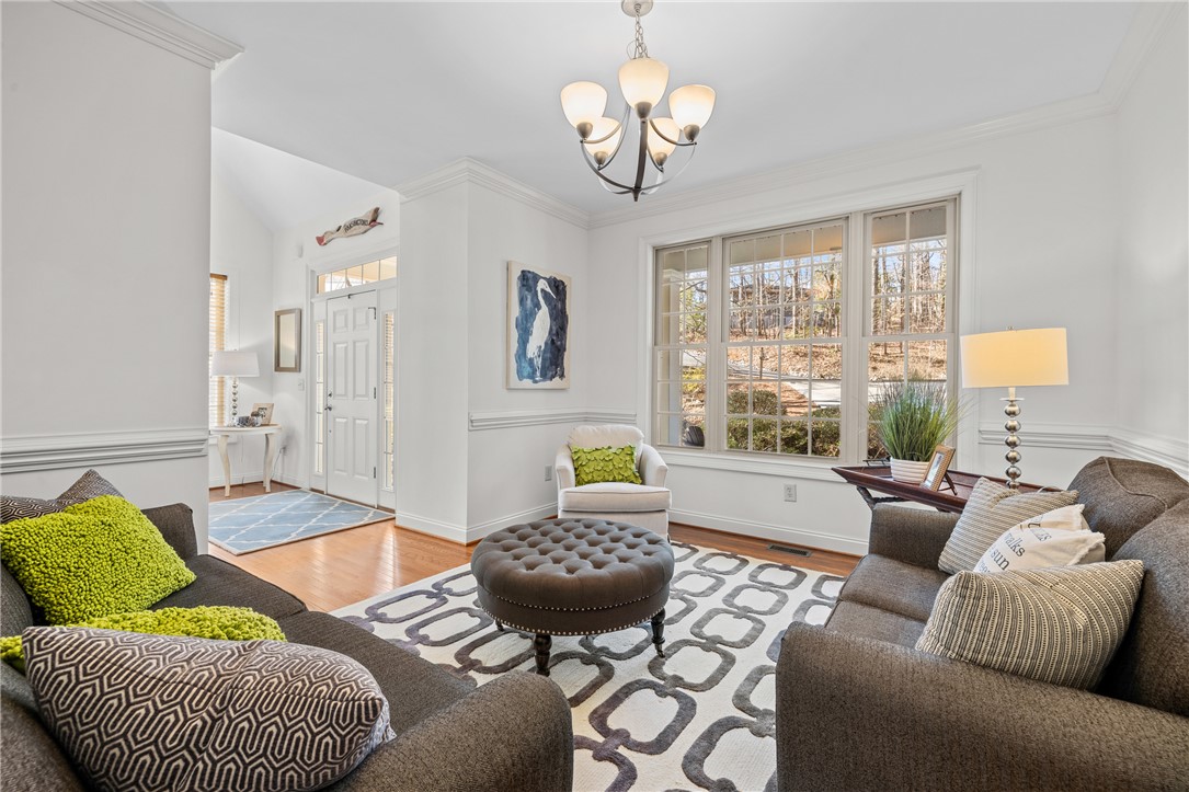 7 Divots Landing Salem, SC 29676 - Photo 7 of 47 This inviting living space features gleaming hardwood floors and large windows offering abundant natural light.