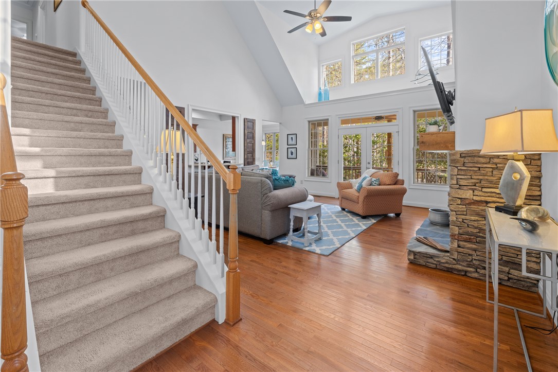 7 Divots Landing Salem, SC 29676 - Photo 8 of 47 This bright living space features soaring ceilings, a stately fireplace, and a welcoming staircase.