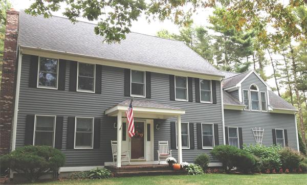 38 Earls Court Rochester, MA 02770 - Photo 1 of 26 a front view of a house with a yard and garage