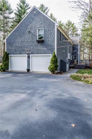 38 Earls Court Rochester, MA 02770 - Photo 23 of 26 a front view of house with yard and trees in the background